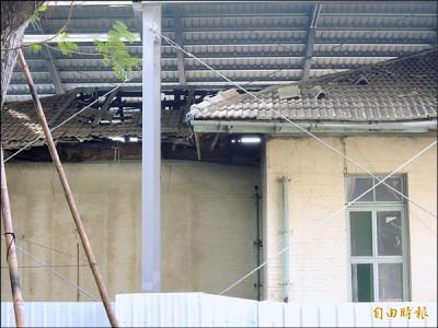 原台南州立農事試驗場辦公廳舍古蹟殘破，只能暫以鐵皮架外罩防護。   （記者洪瑞琴攝）